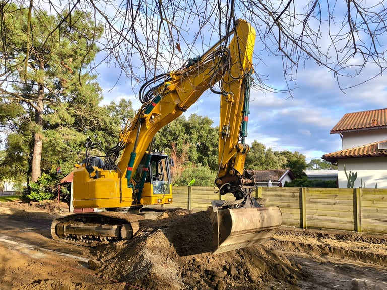 Excavator leveling ground for residential development