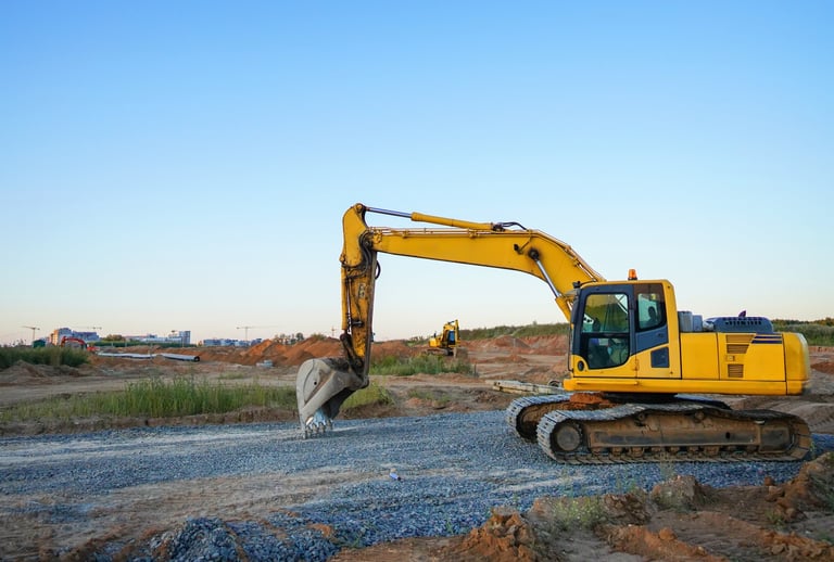Excavator laying sewer pipes